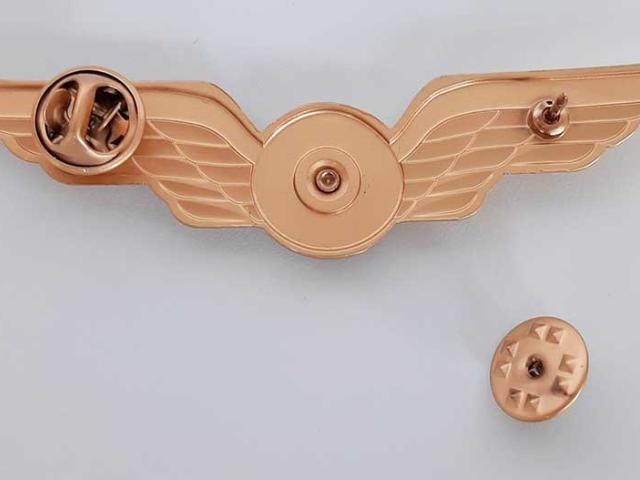 Pilot wing with butterfly clasp