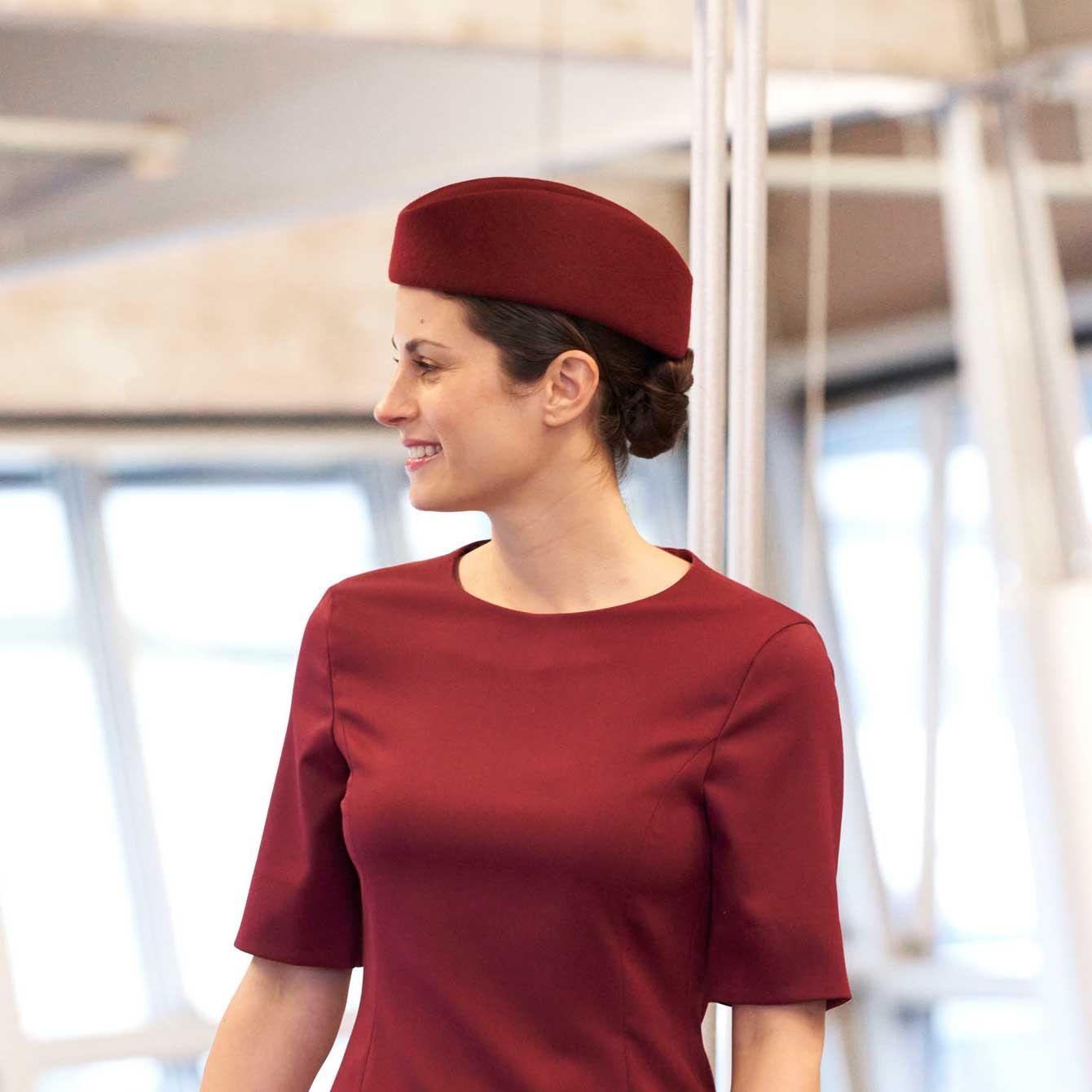 Burgundy airline hat on female cabin crew