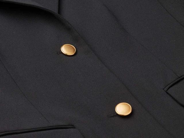 Two golden buttons on uniform jacket
